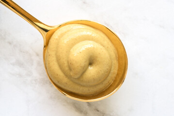 Dijon Mustard on a Golden Spoon - 673361270