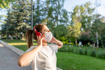 oung fitness sports women runner running in the park. Happy athletic woman listening music on earphones while running in nature in the morning.