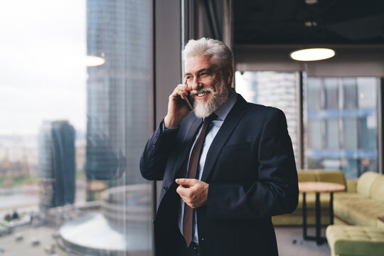 Positive businessman having phone call
