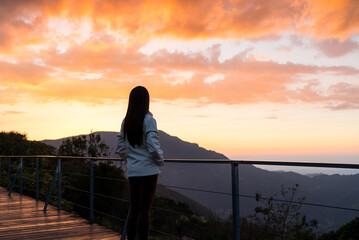Woman look at the sunset mountain view