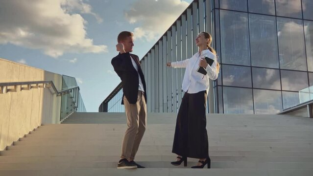 Full shot of office business colleguaes friends man amd woman give high five to each other and say yes. Teamwork, partnership, coworkers concept