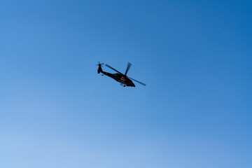 A military Sikorsky helicopter flies in the sky