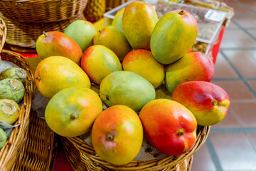 fresh mango apple fruits in a basket on a market