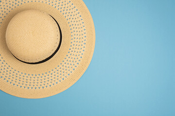 Beach hat on a blue background. Copy space