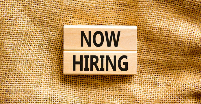 Now hiring symbol. Concept words Now hiring on beautiful wooden block. Beautiful canvas table canvas background. Business marketing, motivational now hiring concept. Copy space.