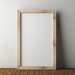 Obraz premium Wooden frame template for showing drawings and pictures. Blank empty frame in wood for showcase. Empty wooden frame leaning against a white wall on a hardwood floor