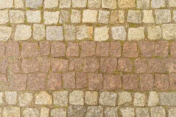 The road is paved with square granite stones.