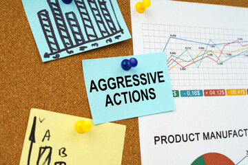 Business charts and stickers with the inscription hang on the board - aggressive actions