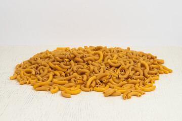 .pasta cones are scattered on the table on a light background