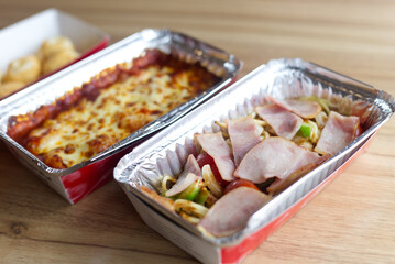side dish Lasagna , spaghett , cheese ball serve on paper Aluminum foil box