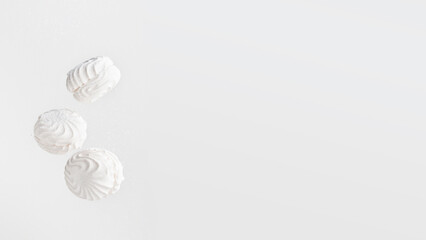 Soaring white zephyr marshmallow on white background. flying food levitation