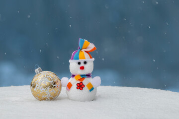 Christmas greeting card with copy-space.Happy snowman standing in christmas landscape.Snow...