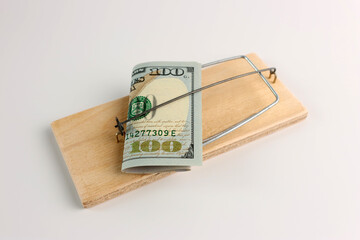 A 100-dollar bill is placed in the mousetrap. Concept of financial trap.