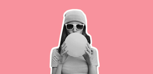 Fashionable portrait of stylish cool young woman inflating chewing gum wearing pink hat on pink...