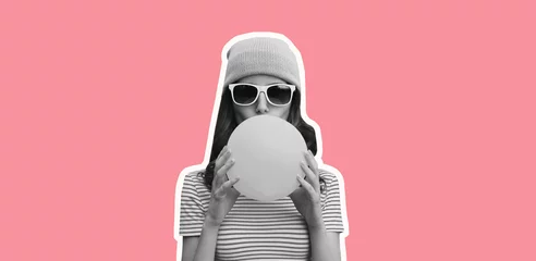 Deurstickers Fashionable portrait of stylish cool young woman inflating chewing gum wearing pink hat on pink studio background © rohappy