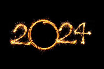 Happy new year 2024 text written with Sparkle fireworks isolated on black background