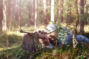 The man Shooting from a gun. Training shooting from an air rifle in the autumn afternoon