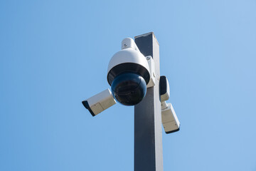 CCTV camera monitoring system with panoramic view outdoor against blue sky. Safety system. Technology concept