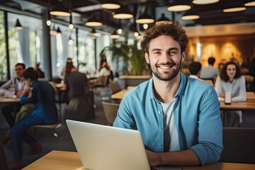 Naklejka na ściany i meble In a modern office setting, a young businessman smiles while collaborating with colleagues, showcasing teamwork and creative success.