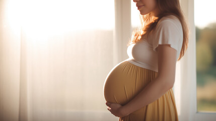 pregnant woman holding her belly - obrazy, fototapety, plakaty