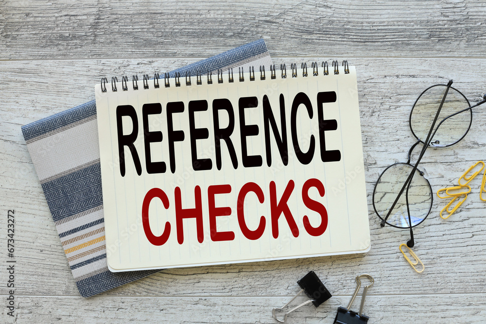 Aufkleber reference checks. notepads on the table text on the page. glasses and stationery.