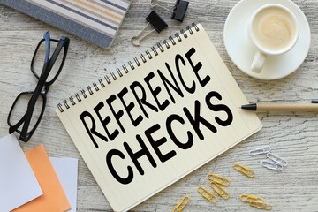 REFERENCE CHECKS notepad with text. a cup of coffee