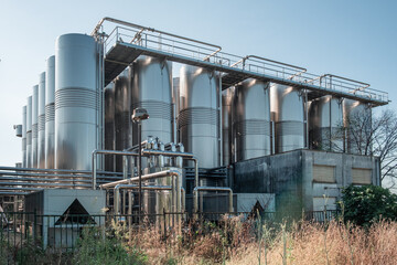 Modern winery plant with stainless steel vats for wine fermentation and autonomous power plant....