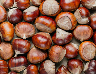 Obraz premium Sweet Chestnuts Top view. Copy space. Pile of ripe chestnuts for food background closeup.