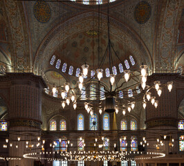 Fototapeta na wymiar Interior of the Sultan Ahmed Mosque (Blue Mosque). Details from inside the historical Sultanahmet Mosque in Istanbul. Turkish Islamic art, history and tourist attractions of Istanbul. Ramadan.