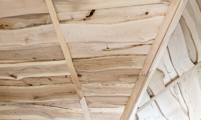 Fototapeta na wymiar The ceiling of the upper floor is covered with boards