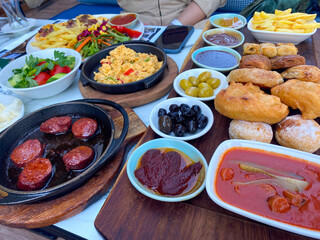 Turkish breakfast with pastries and sausage.