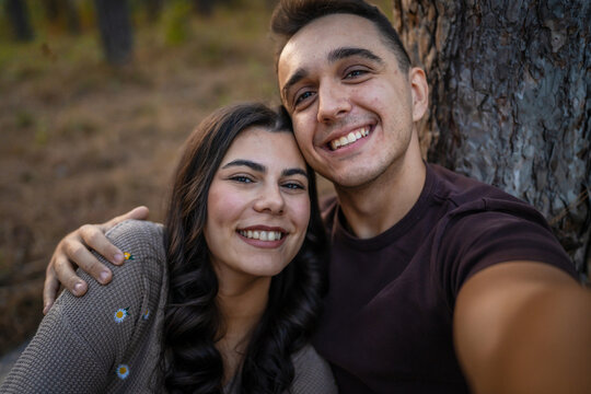 Man and woman young adult couple in nature self portrait selfie ugc