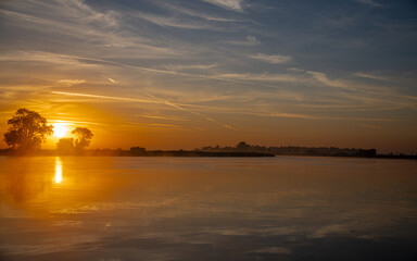 Reflection on the delta with sun and clouds making a beautiful sunrise or sunset 
