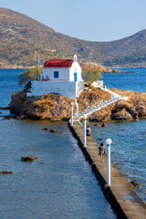 Little church of Agios Isidoros in the sea over the rocks, Leros island, Greece.