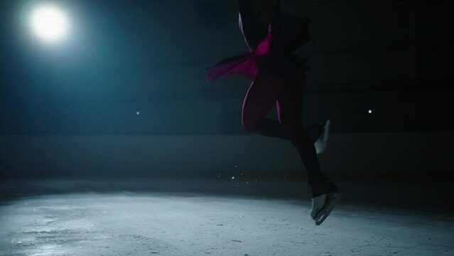 Talented Junior Figure Skater Girl Training On Ice Rink In Darkness, Young Sportswoman Jumping