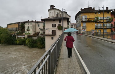 People walking on the bridge in Ponte San Pietro over river Brembo