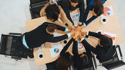 Happy business people celebrate teamwork success together with joy at office table shot from top view . Young businessman and businesswoman workers express cheerful victory show unity support . Jivy - obrazy, fototapety, plakaty