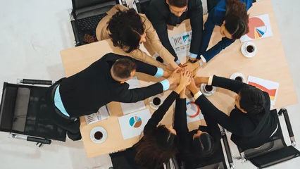 Foto op Canvas Happy business people celebrate teamwork success together with joy at office table shot from top view . Young businessman and businesswoman workers express cheerful victory show unity support . Jivy © Summit Art Creations