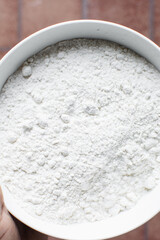 All purpose flour in a ceramic bowl, baking flour in a bowl