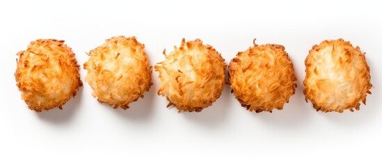 Five coconut macaroons that are sugar free can be seen from a bird s eye perspective and they are separated from the background by placing them on a white surface - obrazy, fototapety, plakaty