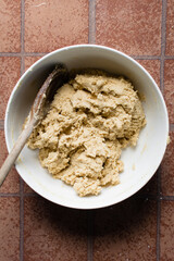 vanilla cookie dough in a white mixing bowl, plain vanilla cookie dough about to be baked