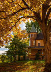Ornate Victorian style home on W Broadway in Decorah Iowa with fall colors
