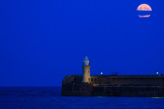lighthouse at night under the full buck moon in Folkestone 2023
