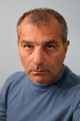 Close up portrait of serious mature male staring at the camera