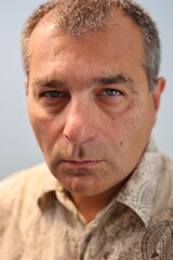 Extreme close up to the face of confident balding mature adult