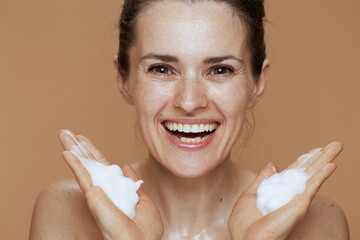smiling young 40 years old woman washing face