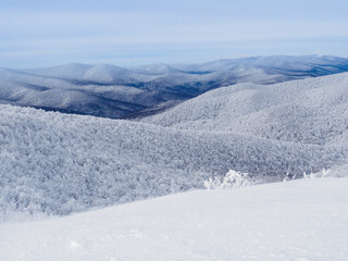Winter mountain landscape. Mountain peaks covered with snow. View from Mala Rawka to Beskid Mounatin Range . Bieszczady Mountains. Poland