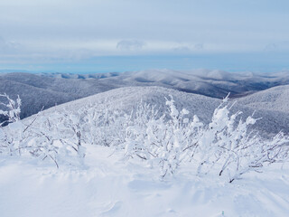 Winter mountain landscape. Mountain peaks covered with snow. View from Mala Rawka to Beskid Mounatin Range . Bieszczady Mountains. Poland
