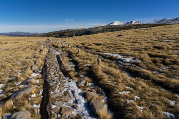 Main path that goes up to the big lake of Gredos Natural park in a sunny winter day. Ávila, Castilla y León, Spain.