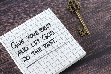 Give your best and let God do the rest, inspiring handwritten quote with ancient key on wooden...